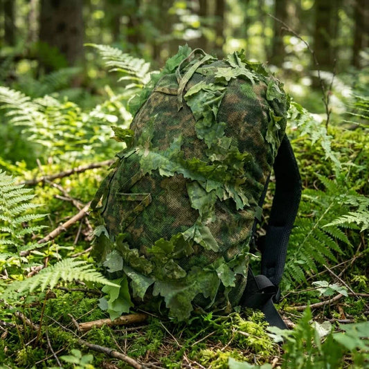 KMCS Bag Cover, featuring a camouflage cover designed to conceal and protect bags in outdoor environments.