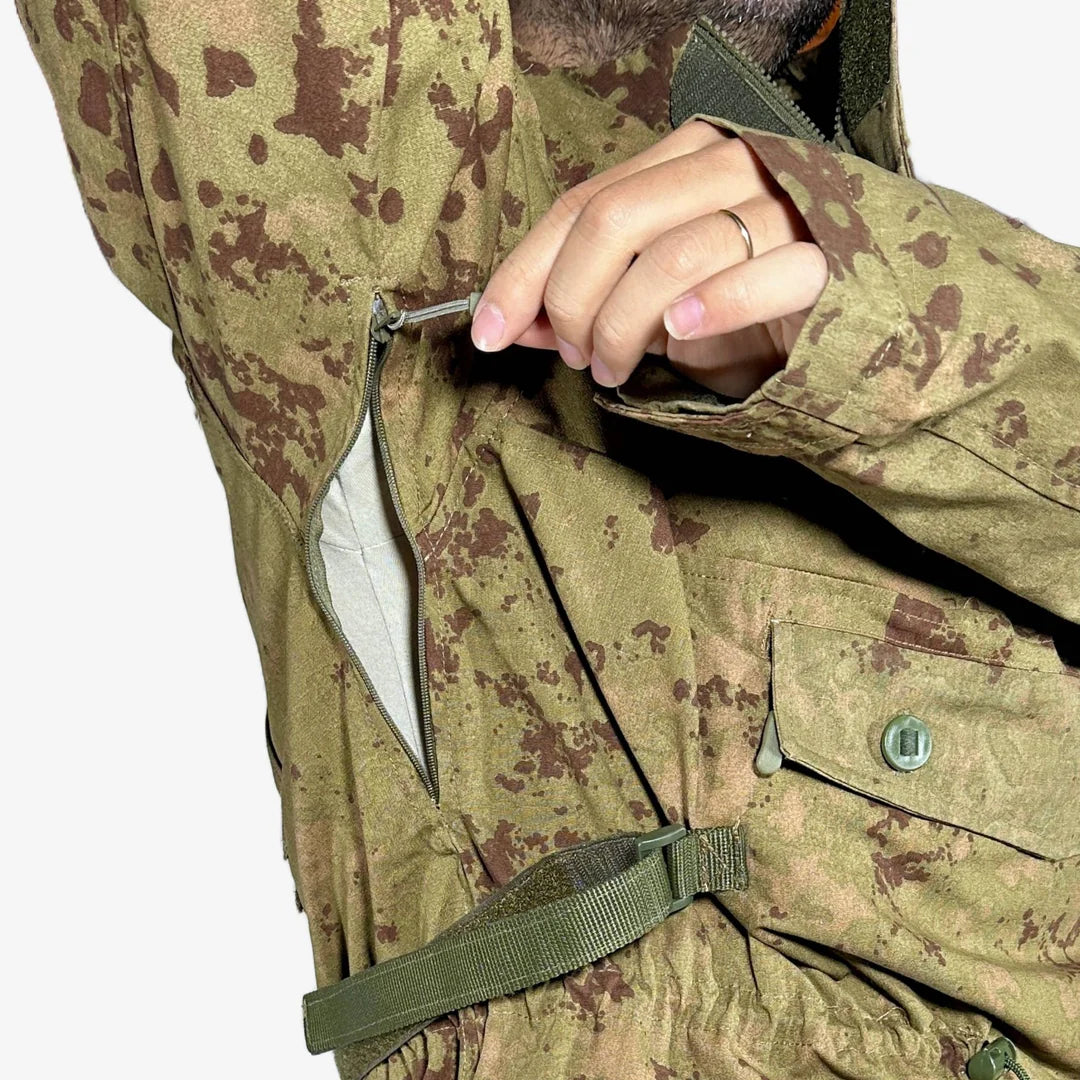 KMCS Field Smock, featuring a camouflage outer layer designed for outdoor concealment and protection.