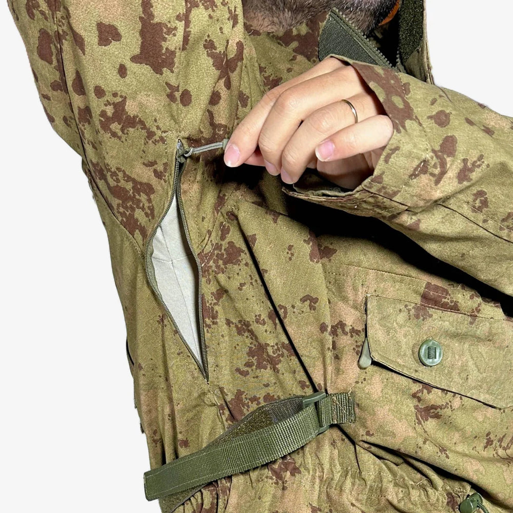 KMCS Field Smock, featuring a camouflage outer layer designed for outdoor concealment and protection.