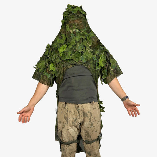 KMCS Python Cloak, featuring a camouflage design with leaf-style elements for outdoor concealment."